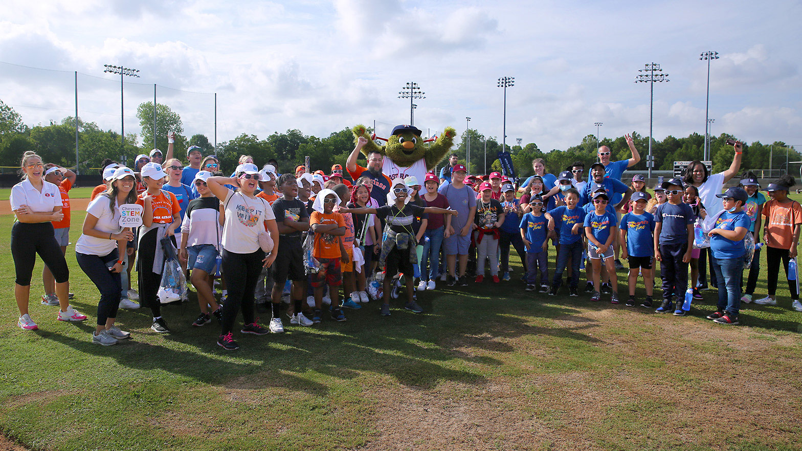 Orbit, the Houston Astros mascot, with crowd of children and adults.