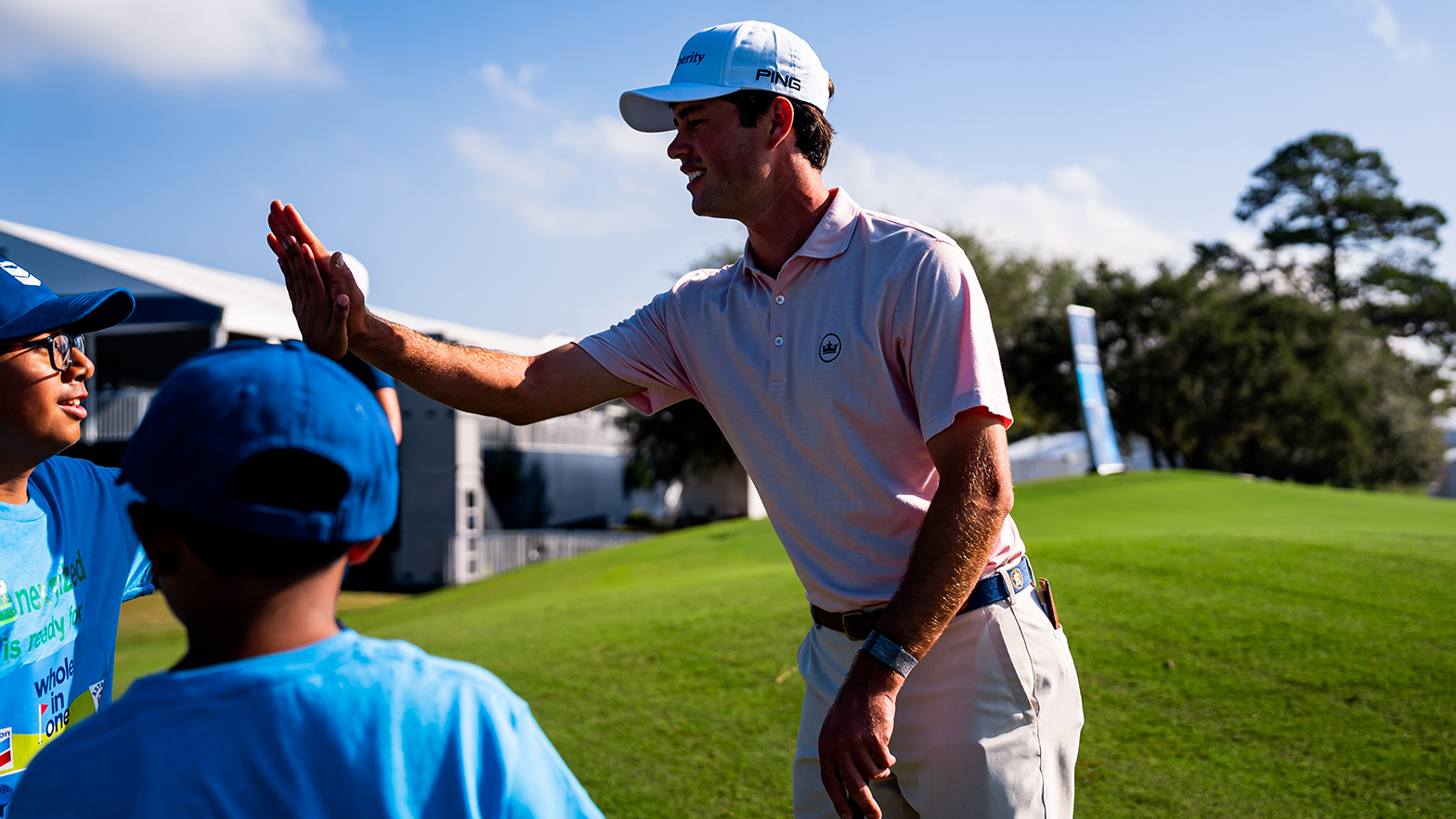 PGA TOUR professional golfer Cole Hammer high-fives a young golfer during our Whole in One golf clinic.