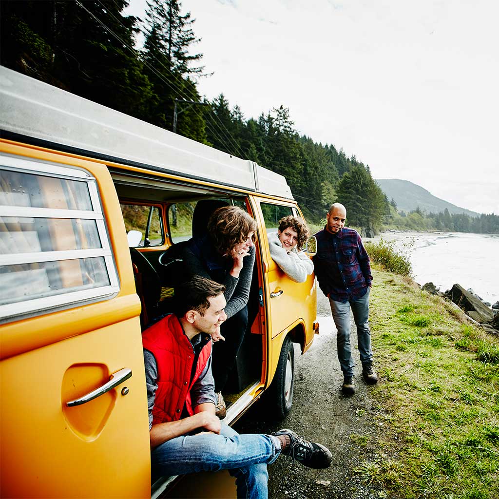 a group of travelers in their van looking at the river
