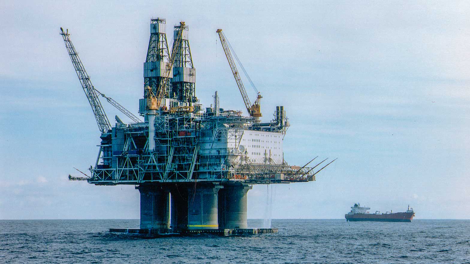 image of an oil rig over the water