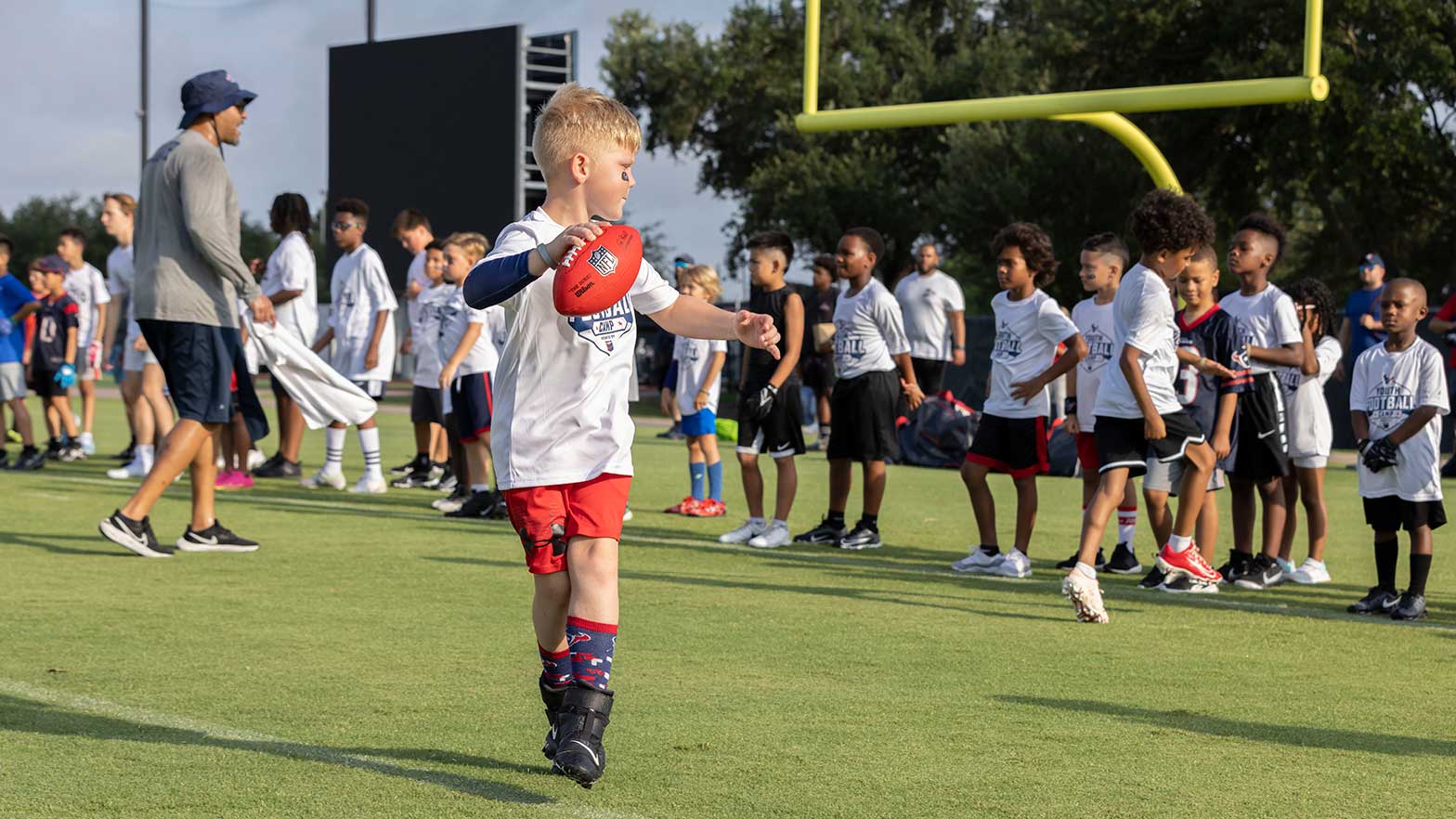 a kid getting ready to throw a football to another player