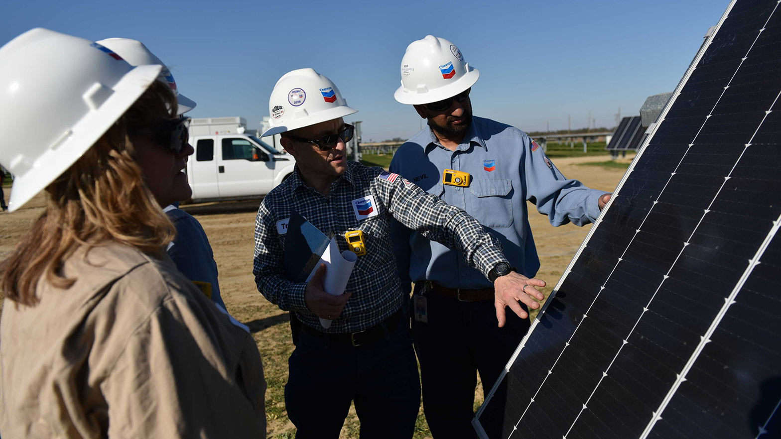 The team at Chevron's Lost Hills facility check on the solar panels that provide electricity to the oil field and soon, the hydrogen production plant.