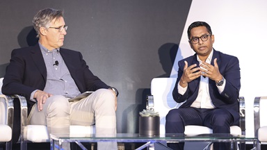 Chevron’s Kaustav Sinha (right) speaks with Niel Hiscox (left), president of Clarify Group, an automotive consulting firm, at Reuters Automotive USA 2023