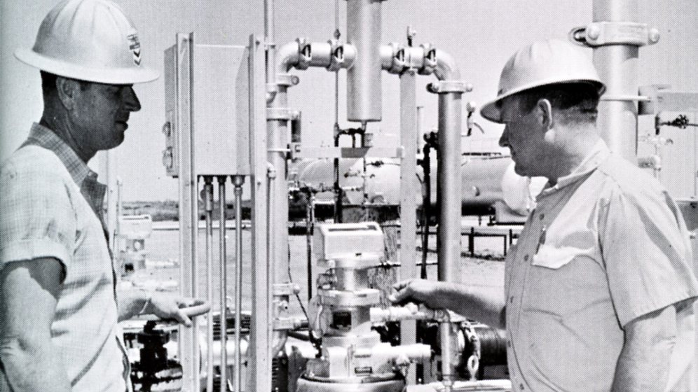 From the Chevron historical archive. Two engineers work on carbon capture equipment at the SACROC oil recovery field. 