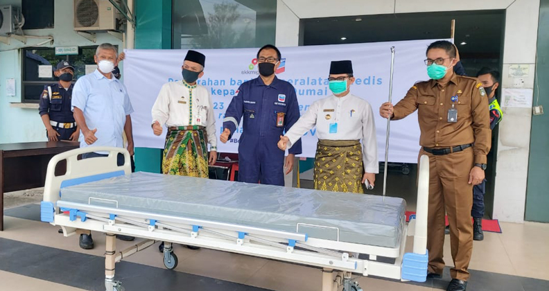 Thai officials with a donated bed