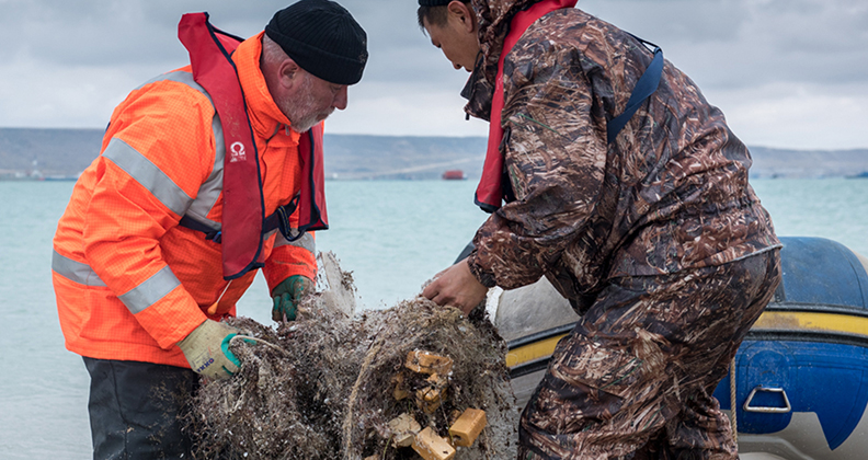 Workers remove marine debris along the Caspian Sea coast