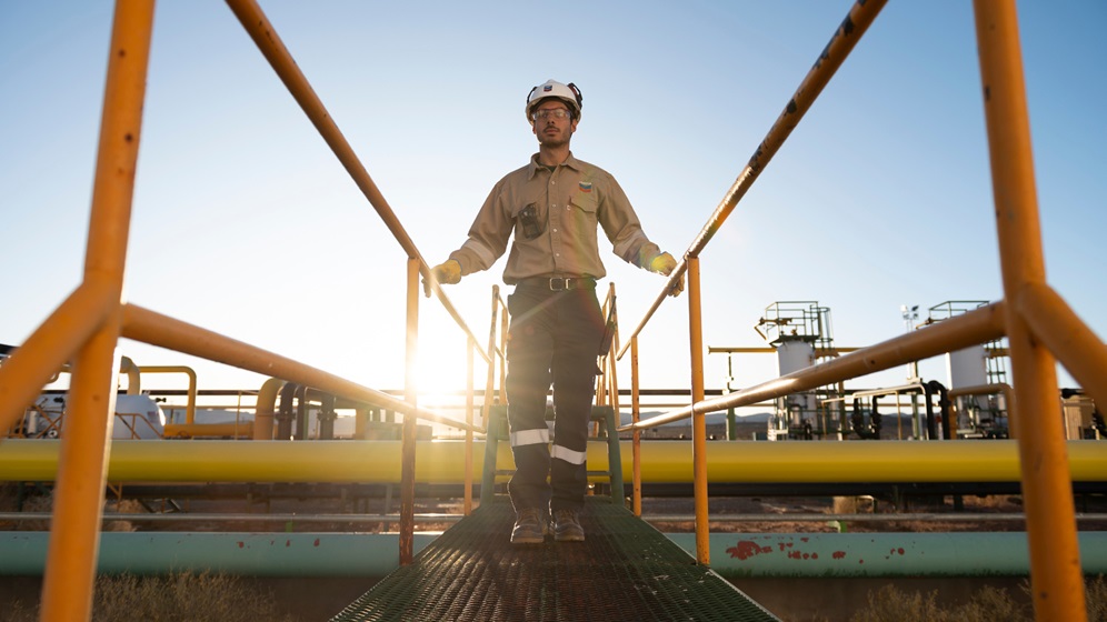 An employee walking on a bridge